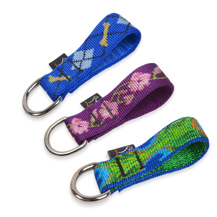 Collar Buddy d-ring extenders in assorted designs on a white background