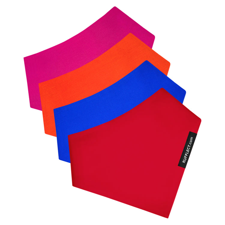 Four square fabric bandanas, red, blue, orange and pink in overlapping fanned arrangement on a white background